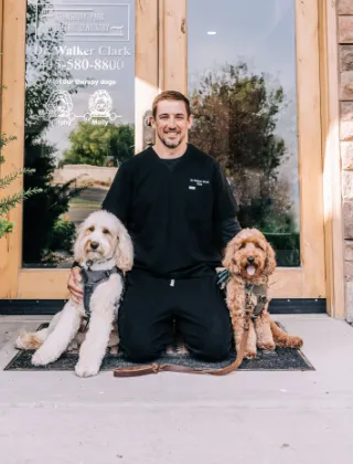 pediatric dentist at door of Stansbury Park with therapy dog